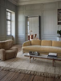 a living room with two couches and a coffee table in the middle of it