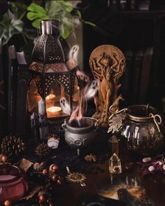 a table topped with lots of different types of candles and other things on top of it