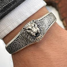 Lion Figure Silver-colored Brass Bracelet for Charisma Men. With its lion's roar design, it will be the indispensable choice of strong charismatic men. It is produced in such a way that it can be used both daily and in a very elegant invitation. This product, which is often preferred by men, can be a great gift.  The wrist size of the product is made of the highest quality brass material and can be adjusted to the desired size. ♦ CARE INSTRUCTIONS ♦ * Remove your necklace before entering the wat Charismatic Men, Lion Head Bracelet, Jewlery Rings, Lion Bracelet, Colored Jewelry, Animal Bracelet, Viking Bracelet, Silver Wolf, Mens Bracelet Silver