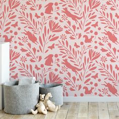 a pink wallpaper with flowers and birds on it, next to two grey bins