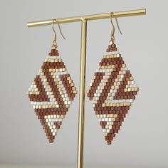 a pair of beaded earrings hanging from a hook