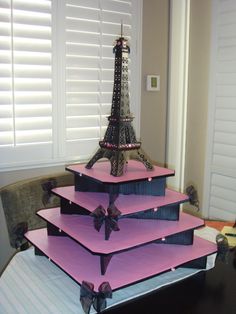 the three tiered tower is made out of purple paper