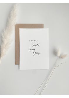 a white card with the words kindness, whatever comes close to you on it next to a feather