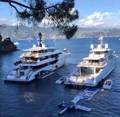 three large boats are docked in the water