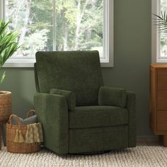 a green chair sitting in front of a window next to a basket and potted plant