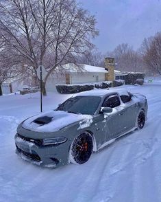 a grey car is parked in the snow