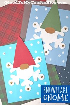 four snowflake gnomes made out of construction paper and some crafting material