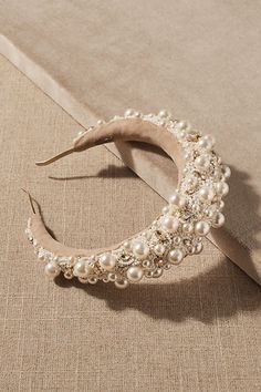 a white headband with pearls on it