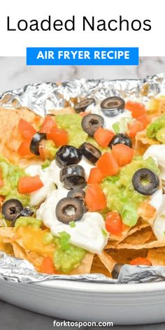 loaded nachos on tin foil with text overlay reading loaded nachos air fryer recipe