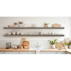 the shelves above the kitchen sink are filled with dishes