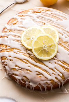 a lemon cake with icing and sliced lemons