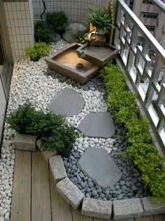 a small garden with rocks and plants in it