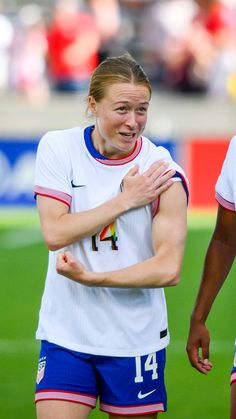 two female soccer players standing next to each other