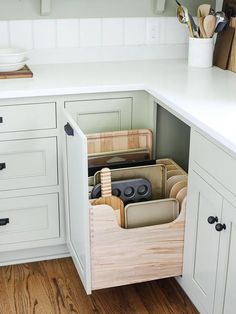 an open drawer in the middle of a kitchen