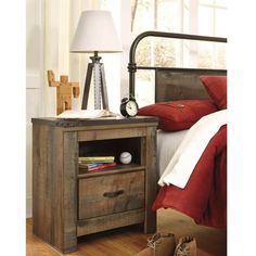 a night stand with two drawers and a lamp