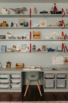 there is a desk and shelves with toys on it in the room that's clean