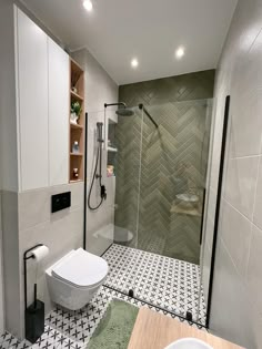 a bathroom with a walk in shower next to a toilet