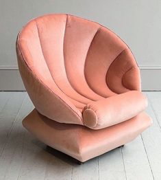 an orange chair sitting on top of a white floor