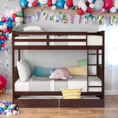 a bunk bed with balloons and streamers on the wall in a child's room