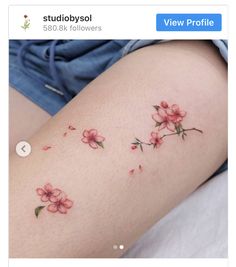 a close up of a person's thigh with flowers on it