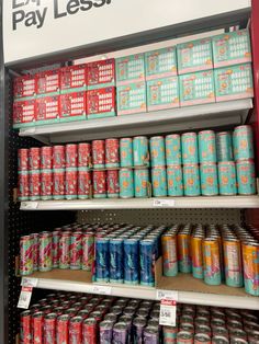 cans of beer are stacked on shelves in a store