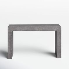 a concrete table sitting on top of a white floor