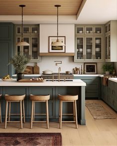 an image of a kitchen setting with green cabinets and stools on the countertop