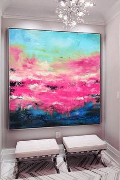 two white stools are in front of a large pink and blue painting on the wall