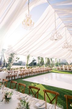 an outdoor reception setup with tables and chairs