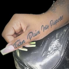 a hand with writing on it that says, turn rain into purpose in black ink