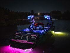 a boat that is sitting in the water with lights on it's headlight