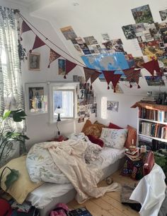 a bed sitting in a bedroom next to a book shelf filled with lots of books