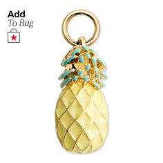 a gold pineapple keychain with turquoise stones on it's front and bottom