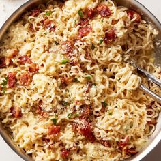 a pan filled with pasta and sauce on top of a table