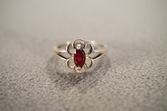 I am offering you this vintage sterling silver wedding band stacker design ring.  This features a raised relief  single stone setting.  This has a prong set marquise shaped genuine Garnet stone set in it.  This ring is currently a size 7 3/4, though I am sure it could be sized up or down. Please review all of my pictures, as they are all a very important part of , my listing/descriptions. Vintage White Gold Stackable Rings For Anniversary, Silver Stackable Birthstone Ring For Formal Occasions, Vintage Stackable Jewelry With Round Band, Vintage Ruby Ring Stamped 925 For Formal Occasions, Vintage Solitaire Promise Ring Jewelry, Vintage White Gold Stackable Jewelry, Vintage Solitaire Jewelry, Vintage White Gold Birthstone Ring, Vintage Sterling Silver Anniversary Rings