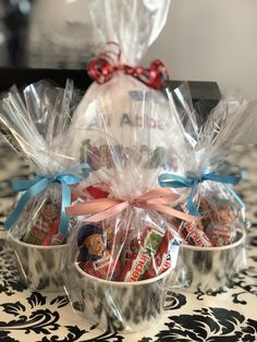 three baskets filled with candy sitting on top of a table