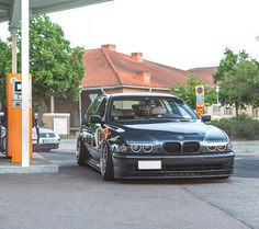 a black car parked at a gas station