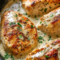 some chicken is cooking in a pan with sauce and parsley on the top side