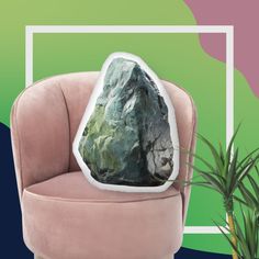 a rock sitting on top of a pink chair next to a potted green plant