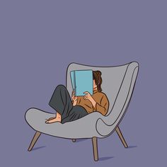 a woman sitting in a chair reading a book