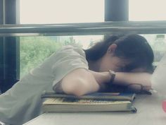 a woman leaning her head on a book