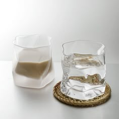 an empty glass sitting on top of a table next to a bowl and saucer