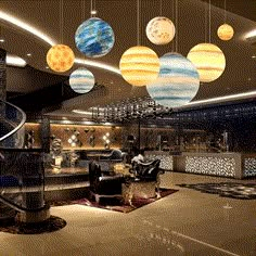 a living room filled with furniture and hanging planets