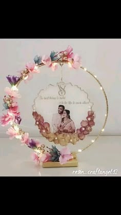 a photo frame with flowers and lights around it