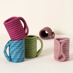 three different colored ropes stacked on top of each other in the shape of mugs