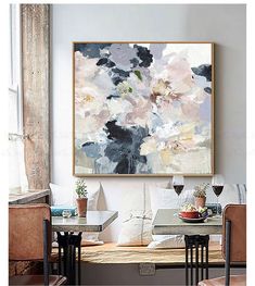 a painting hanging on the wall above a dining room table