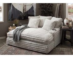 a large white couch sitting on top of a rug