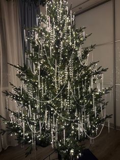 a christmas tree is decorated with white lights