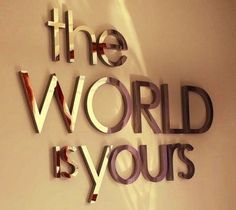 the word world is yours written in cut out letters on a white wall with shadows