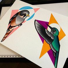 two colorful birds sitting on top of each other in front of a ruler and paper